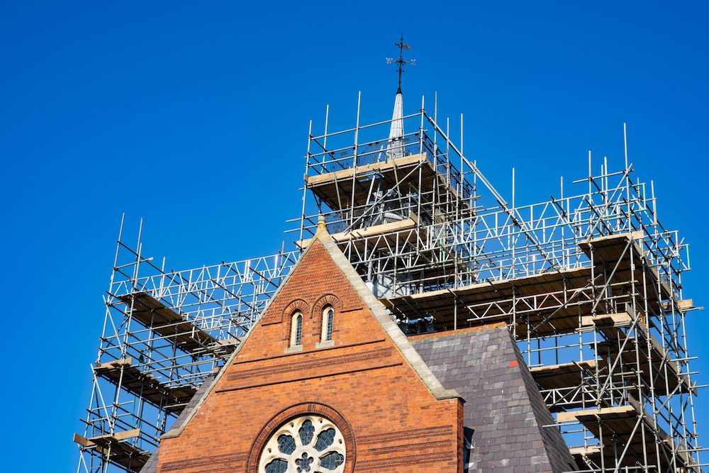 A Clock Tower is Being Restored With Scaffolding Around It — Byron Bay Scaffold in Palm Beach, QLD