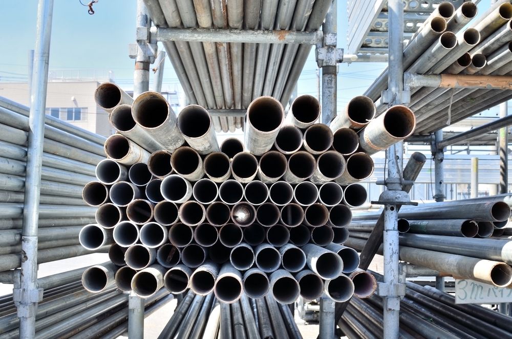 A Bunch of Pipes Are Stacked on Top of Each Other on a Shelf — Byron Bay Scaffold in Tweed Heads, NSW