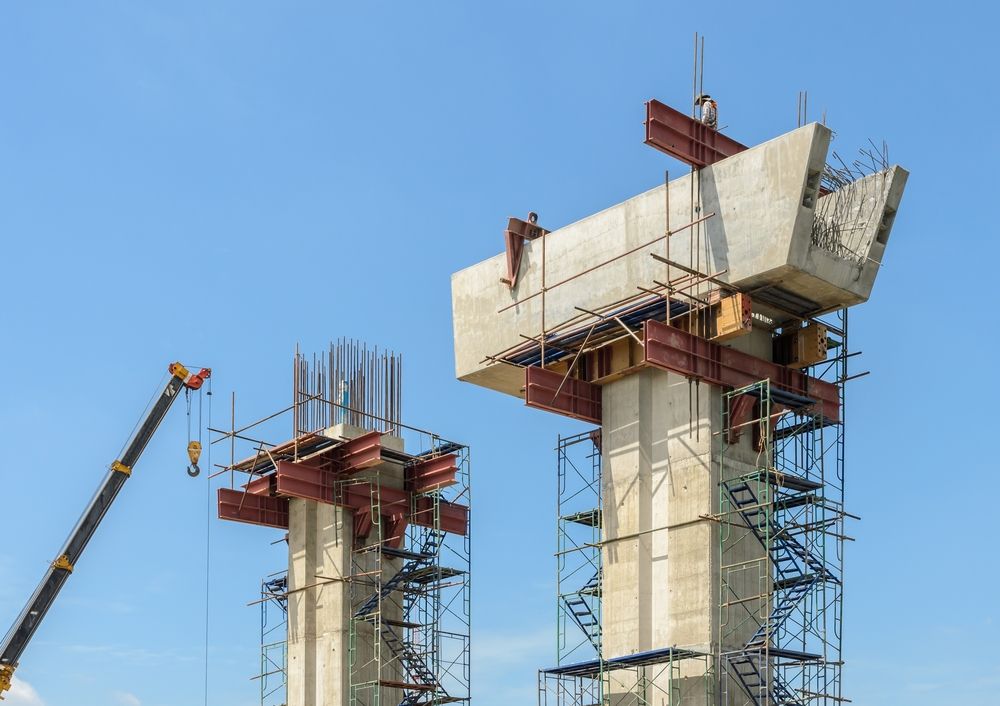A Bridge is Being Built With a Crane in the Background — Byron Bay Scaffold in Coolangatta, QLD