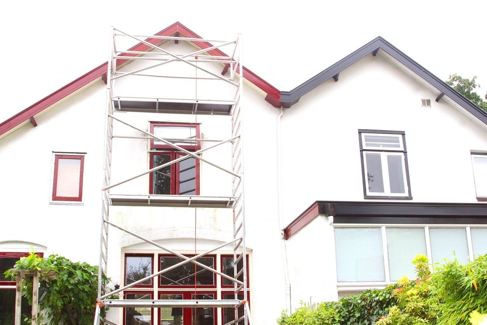 A White House With a Red Roof and a Scaffolding in Front of It — Byron Bay Scaffold in Kinvara, NSW