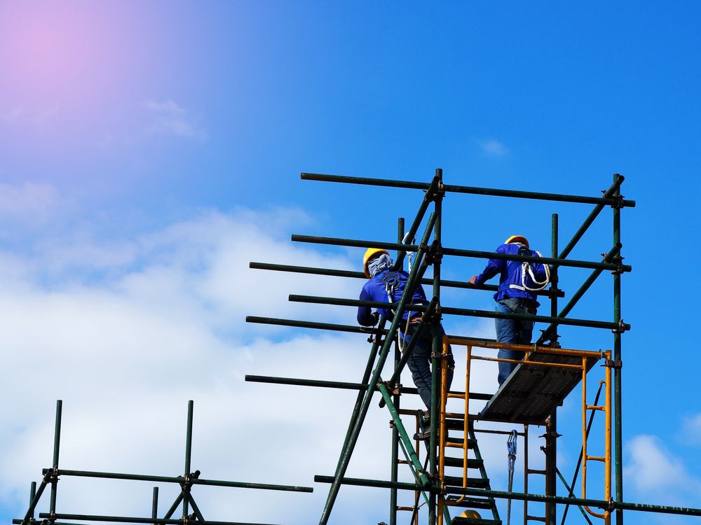 Two Construction Workers Are Working on a Scaffolding Structure — Byron Bay Scaffold in Kingscliff, NSW