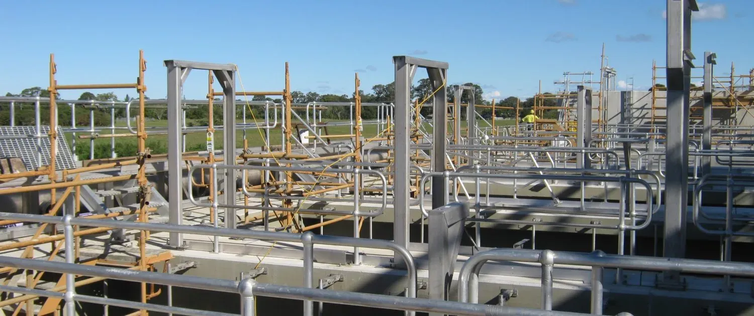 A Construction Site With a Lot of Pipes and Scaffolding — Byron Bay Scaffold in Ballina, NSW