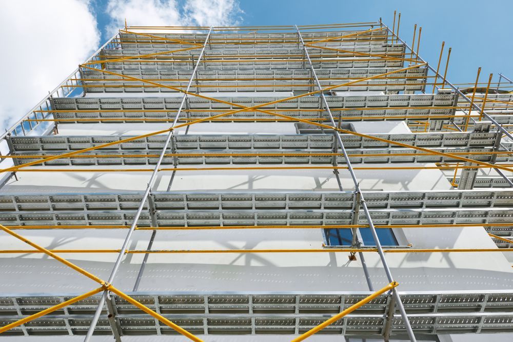 A Large Building is Being Built With Scaffolding and a Blue Sky in the Background — Byron Bay Scaffold in Kinvara, NSW