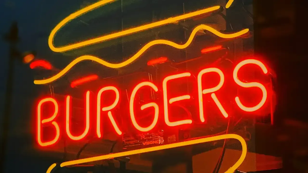 a neon sign that says burgers on it