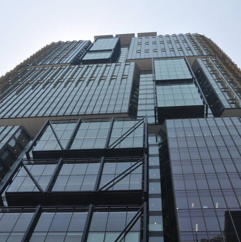 Looking up at a tall building with lots of windows