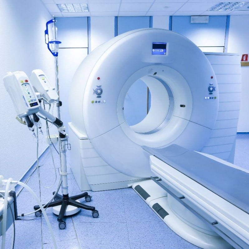 A hospital room with a large ct scan machine