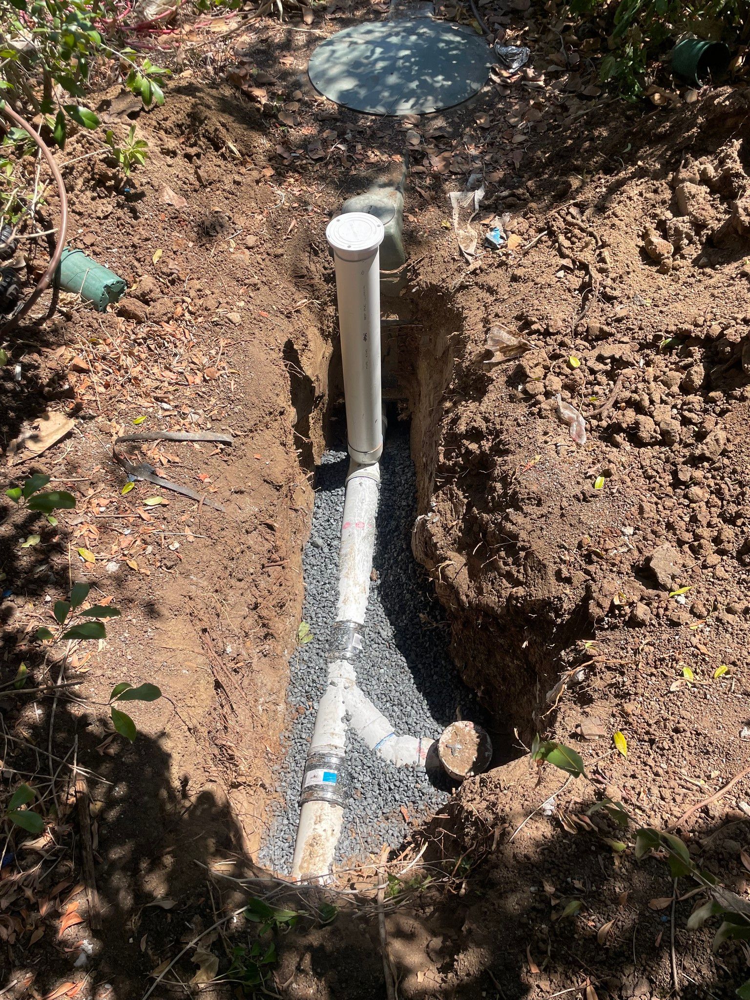 A White Rainwater Diverter And Gutter Outlet Attached To A House Roof — Mates Plumbing and Gas in Lammermoor, QLD