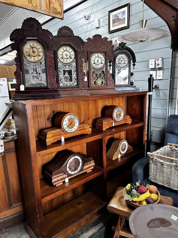 Antique Clocks Displayed on a Wooden Bookshelf — Clancy's Office And  Emporium in Taree, NSW