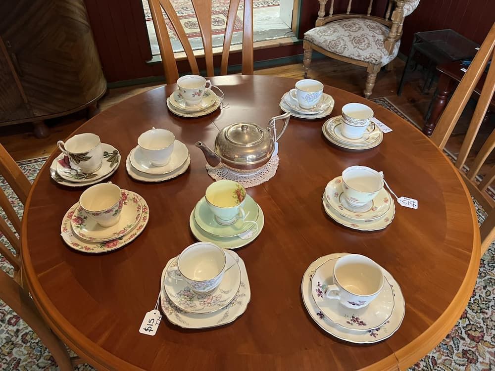 A Round Wooden Table Set for Tea With Cups, Saucers, and a Silver Teapot — Clancy's Office And  Emporium in Taree, NSW