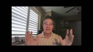 A man wearing glasses is talking on a video call in front of a window.