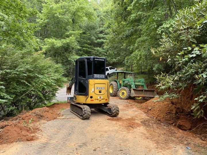 Tractor driving down a dirt road