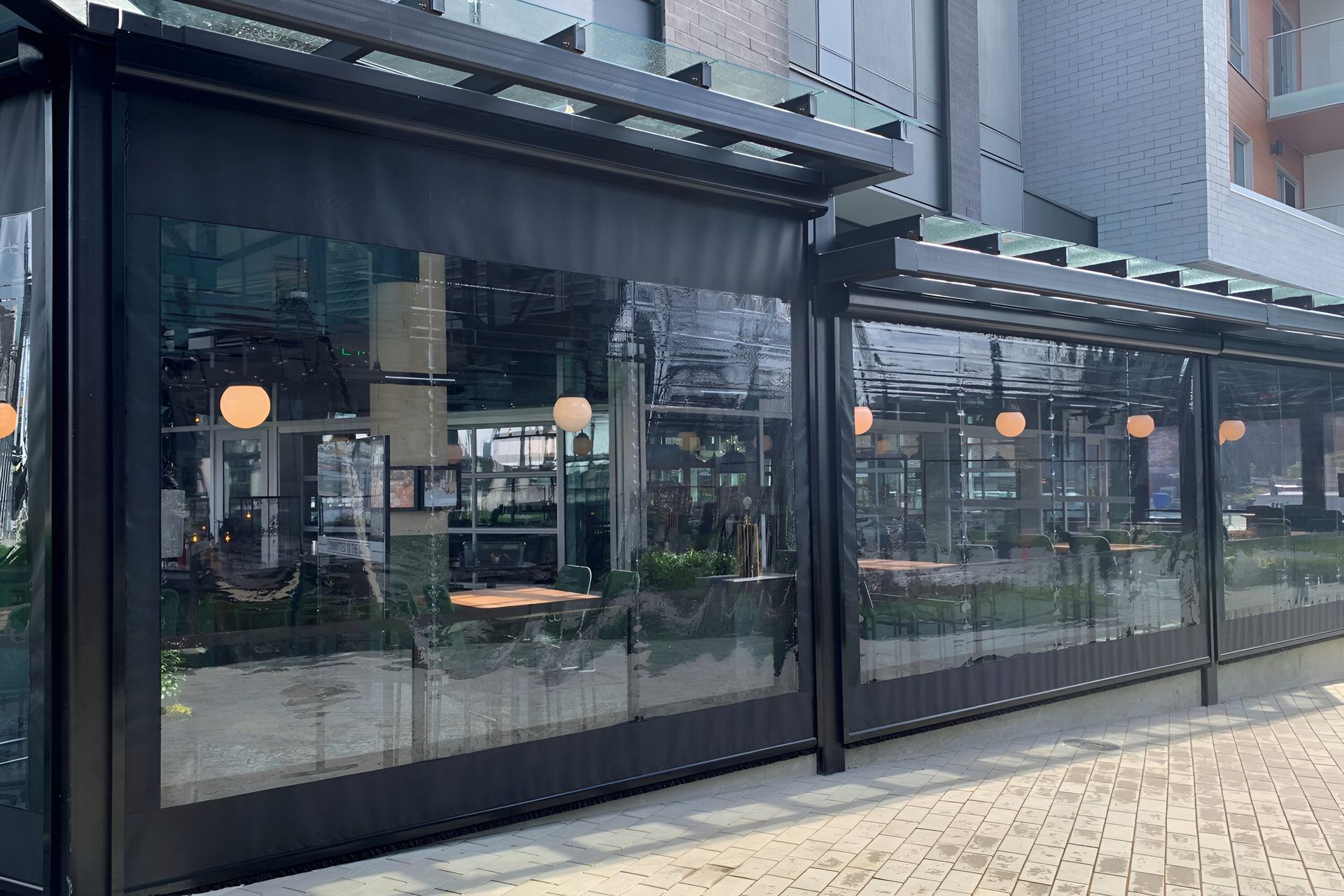 A restaurant with tables and chairs outside of it.