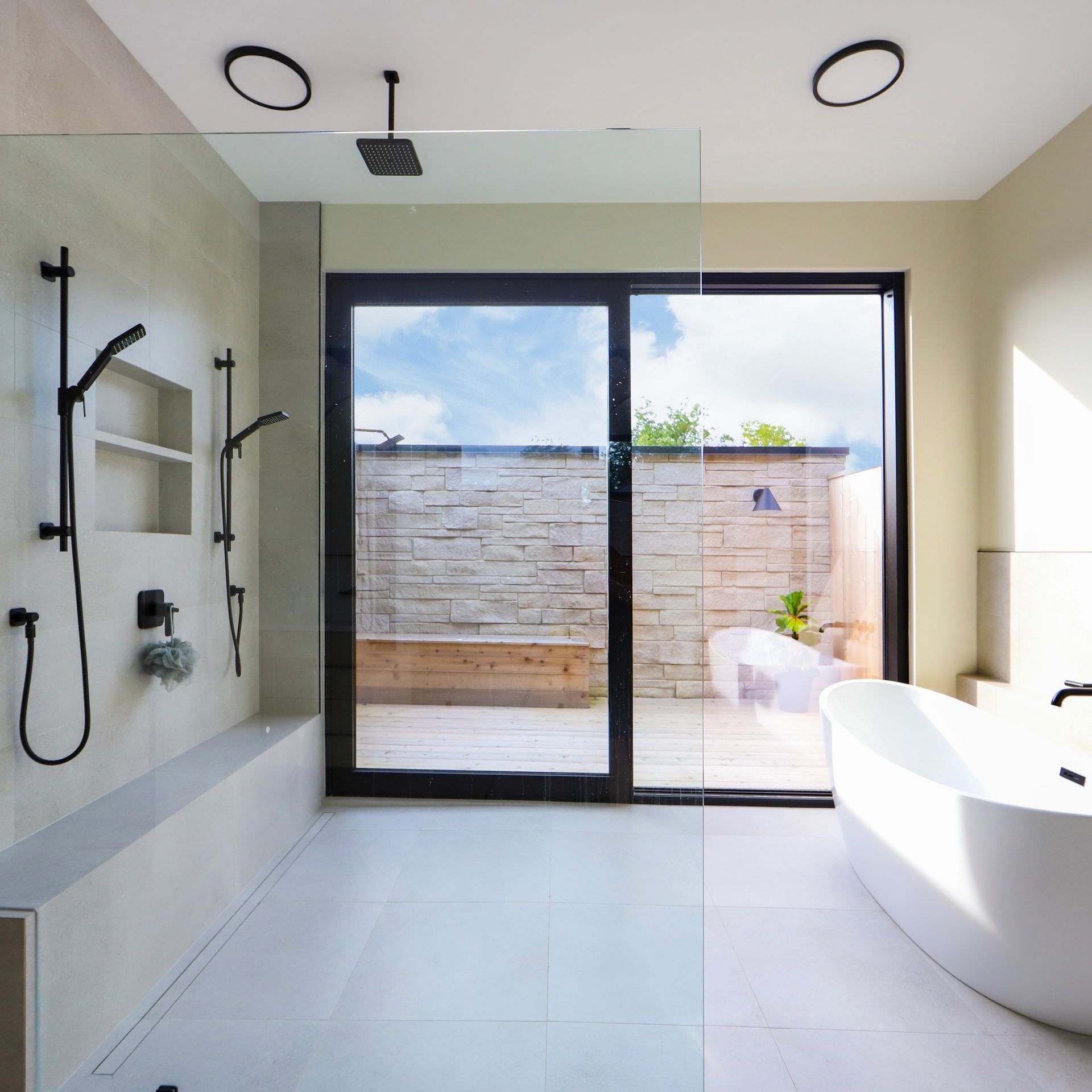 A bathroom with a tub and a sliding glass door