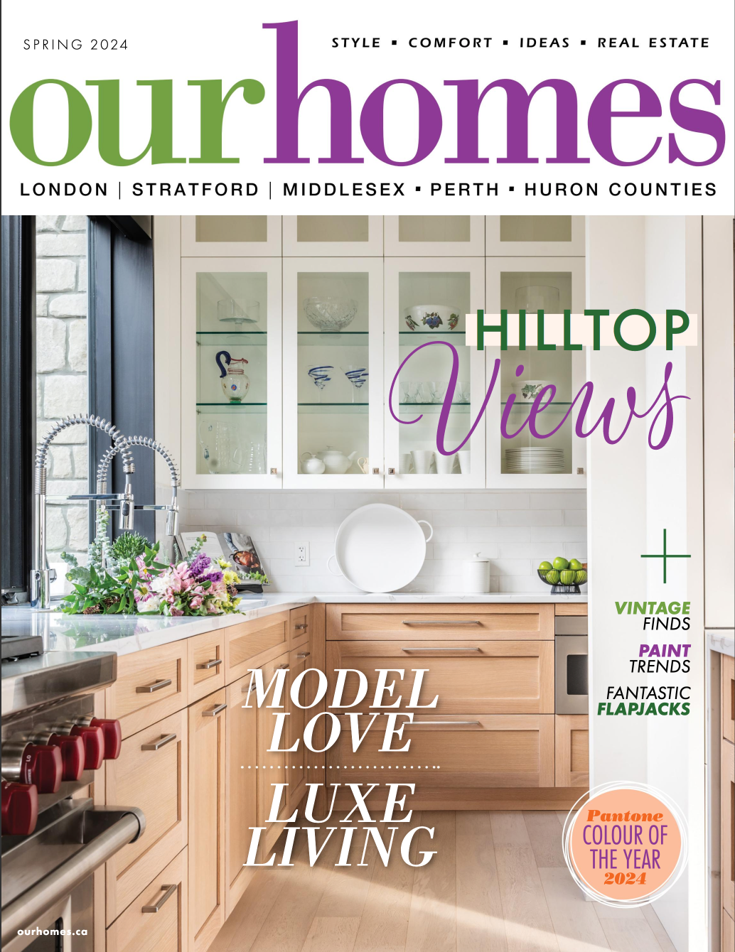 The cover of our homes magazine shows a kitchen with wooden cabinets and a sink.
