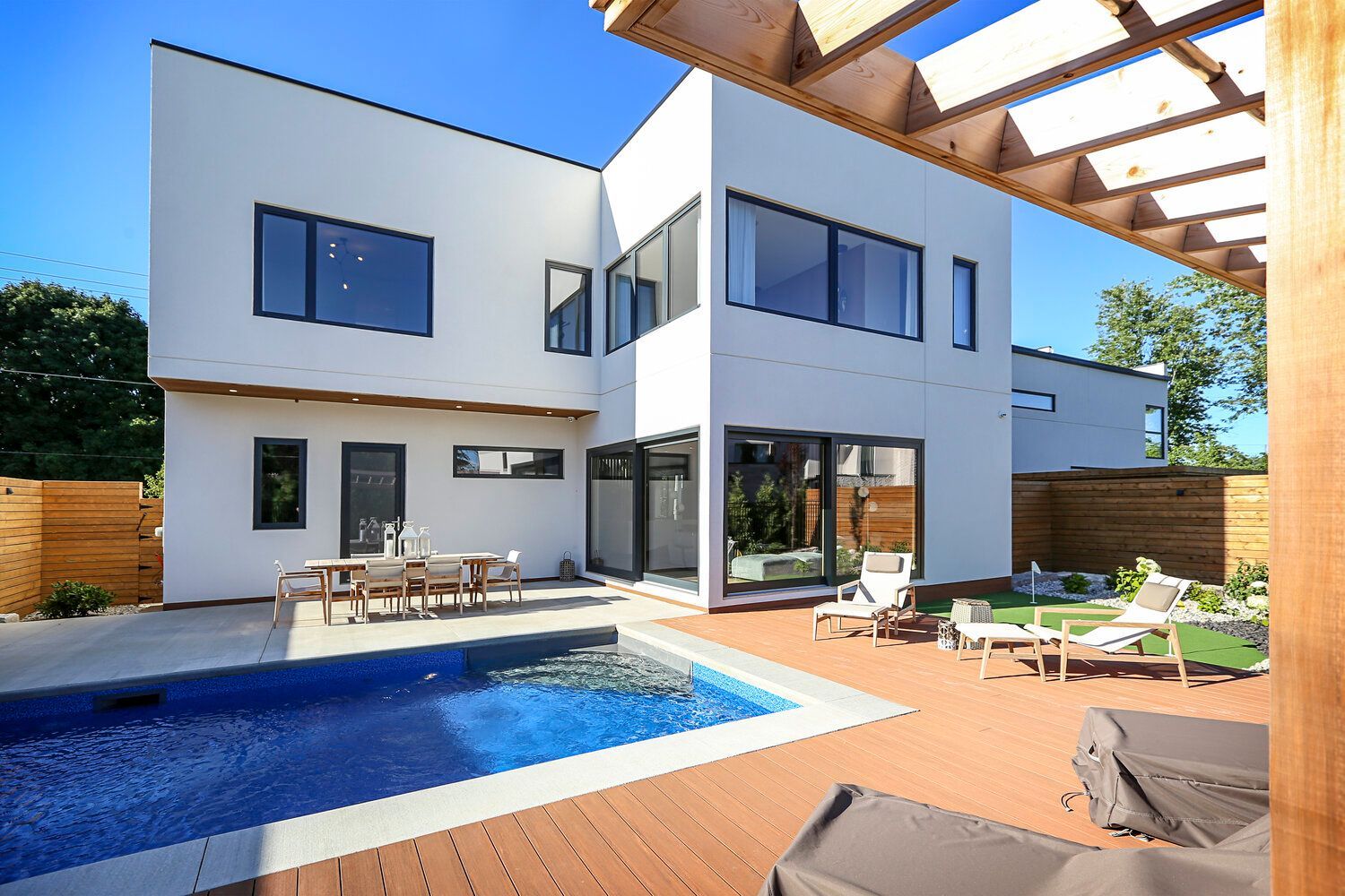 A large white house with a swimming pool in the backyard