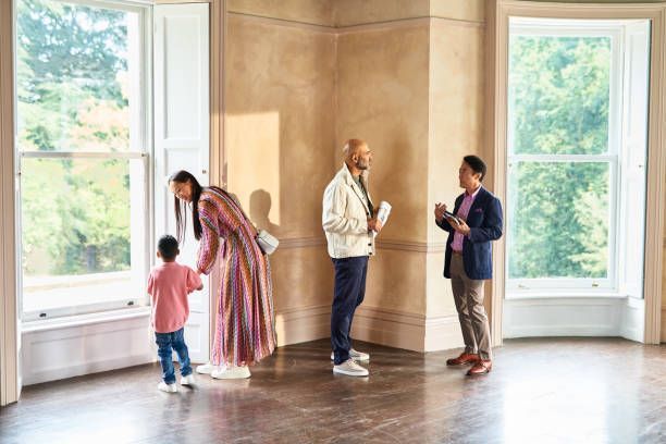 A family is looking at a house with a real estate agent.