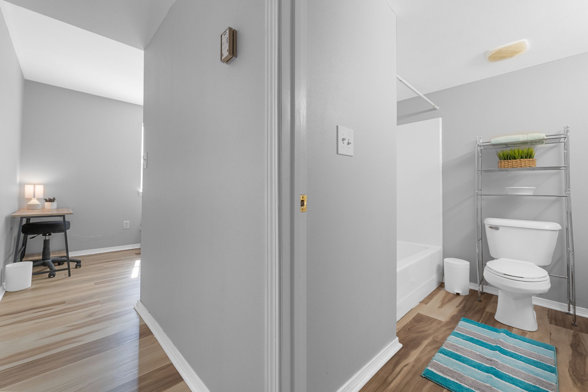A bathroom with a toilet , bathtub , and rug.