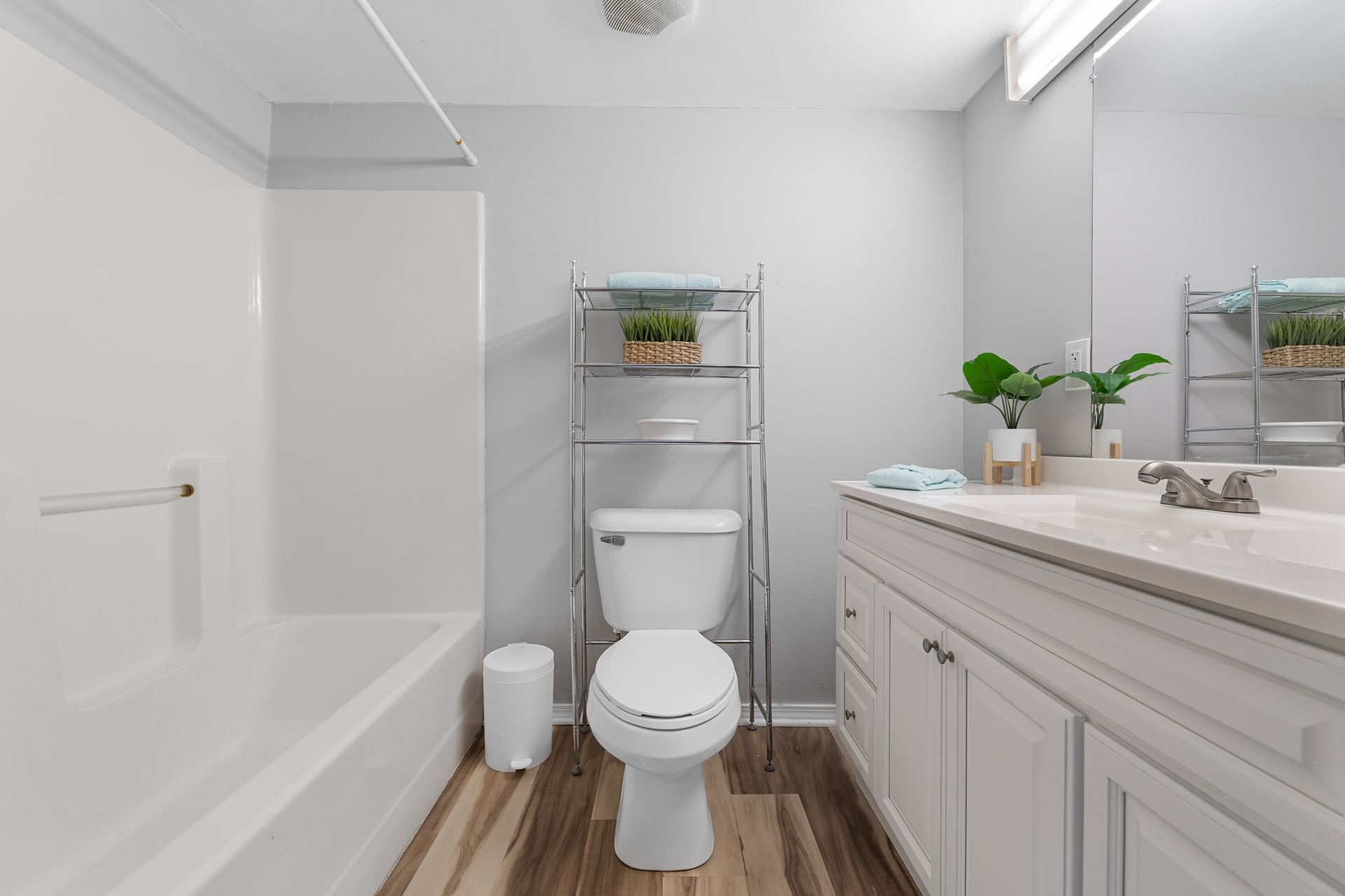 A bathroom with a toilet , sink , and bathtub.