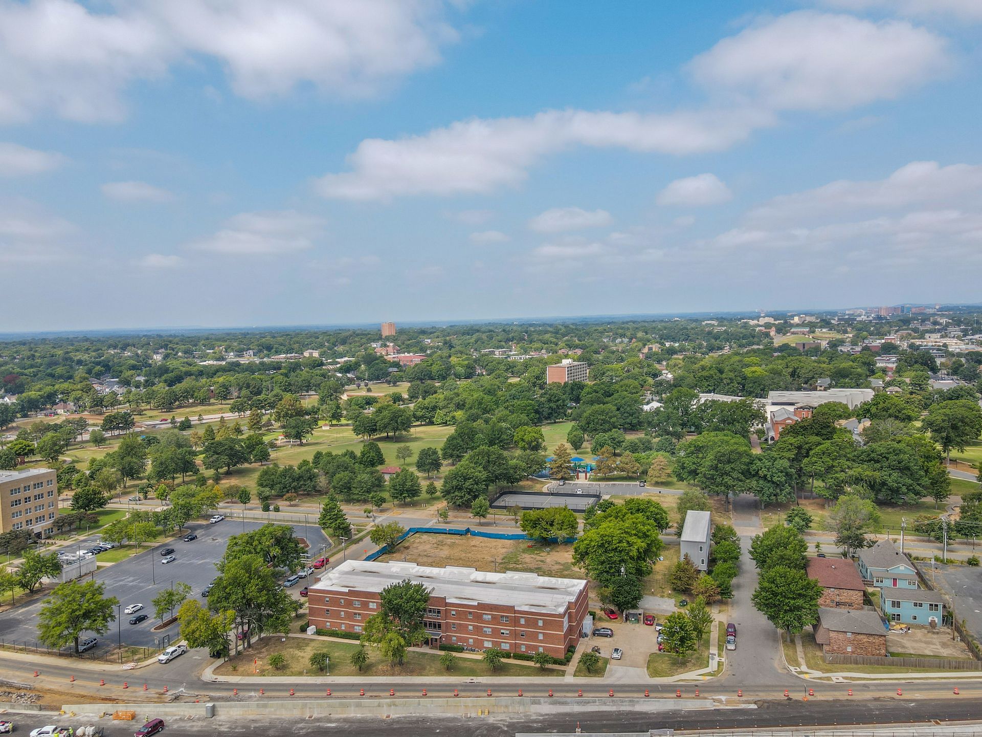 An aerial view of a city with a lot of trees and buildings.