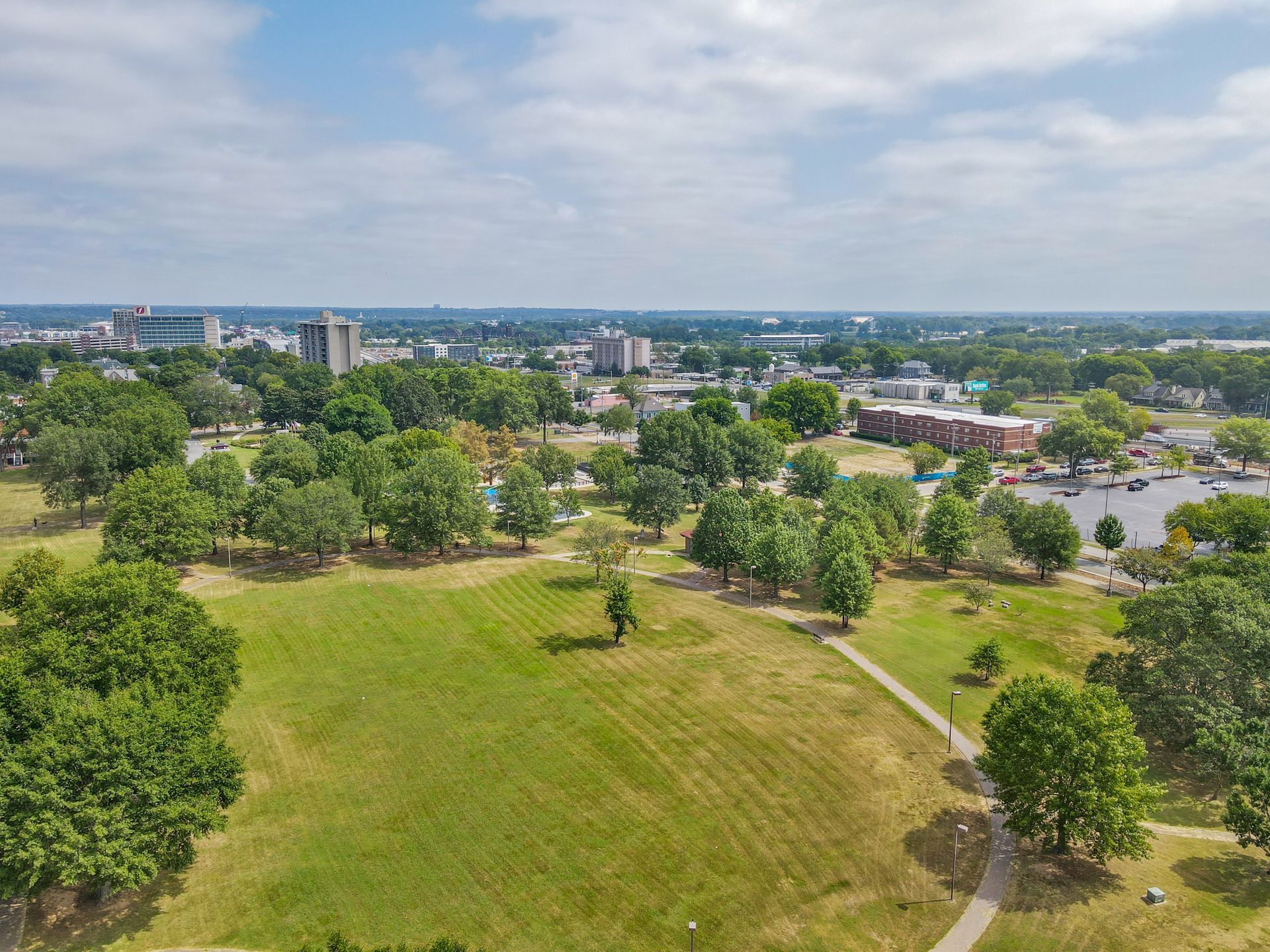 An aerial view of a park filled with lots of trees and grass.