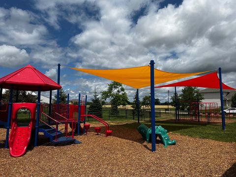 A colorful playground with shades and a slide