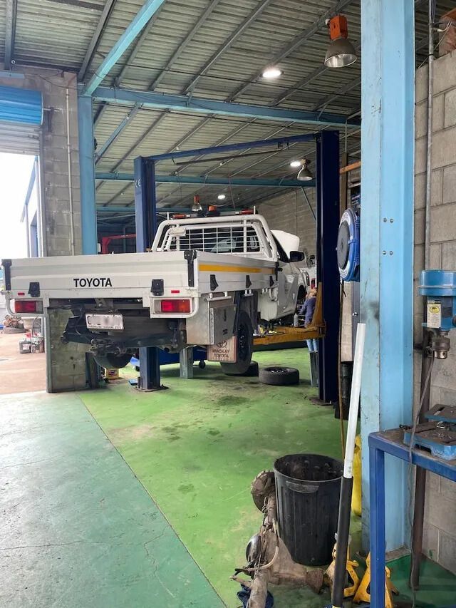 A Toyota Truck Is Sitting On A Lift In A Garage — Mackay Car & Commercial Pty Ltd In Paget, QLD