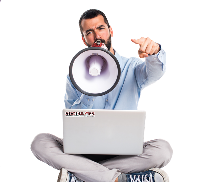 A man is holding a megaphone in front of a laptop computer.