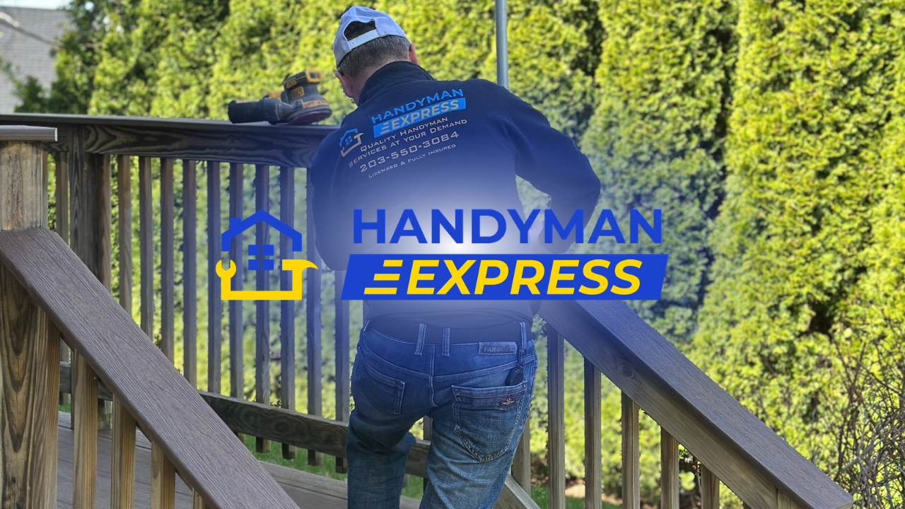 Handyman Express worker on a wooden deck by greenery, seen from behind holding a railing