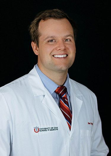 a man in a lab coat and tie is smiling for the camera - Dr. Ben Fogg