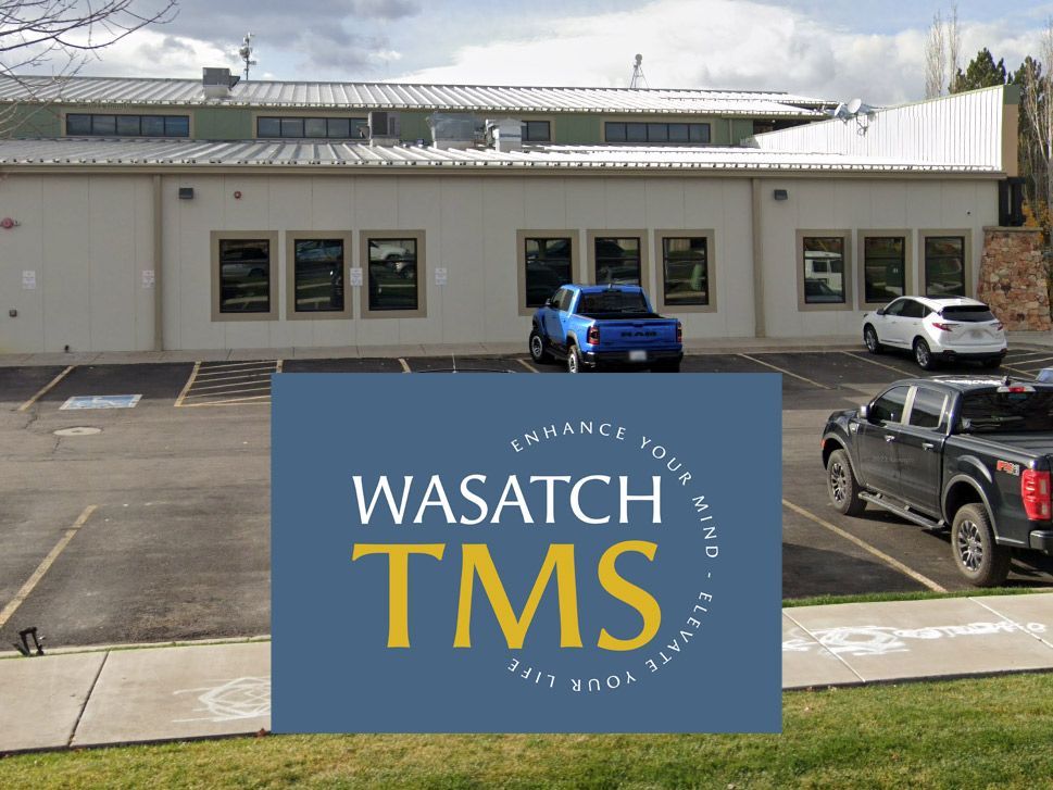 A wasatch tms sign is in front of a building