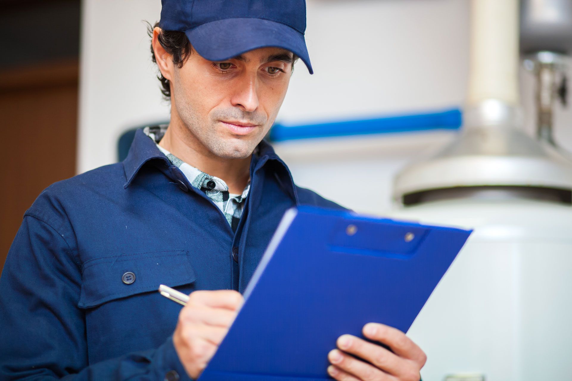 Technician servicing an hot-water heater Technician servicing an hot-water heater