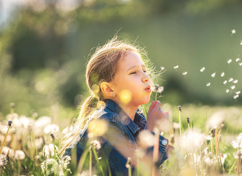 child playing outside in the grass - allergy and asthma of maryland
