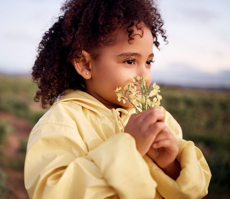young girl smelling flowers - allergy treatment for seasonal and environmental allergies - maryland