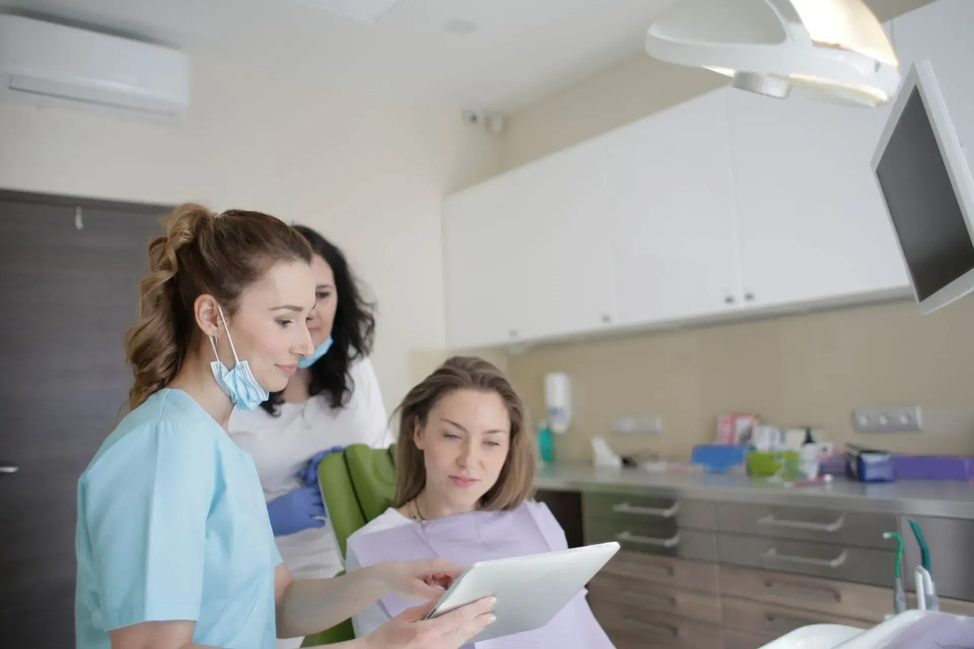 Dentist providing written post-operative care and recovery guidelines to a patient at Upstate Smiles