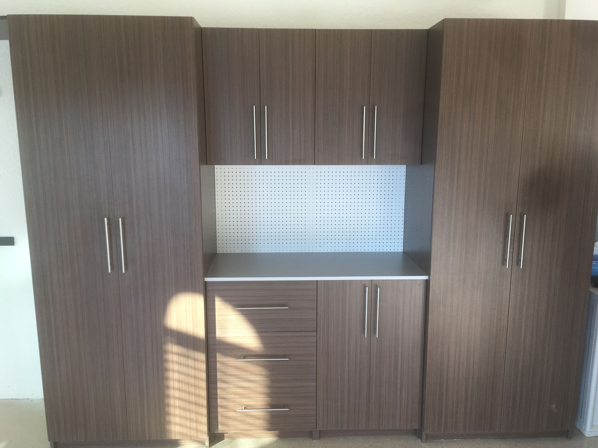 A kitchen with a lot of cabinets and drawers and a counter top.