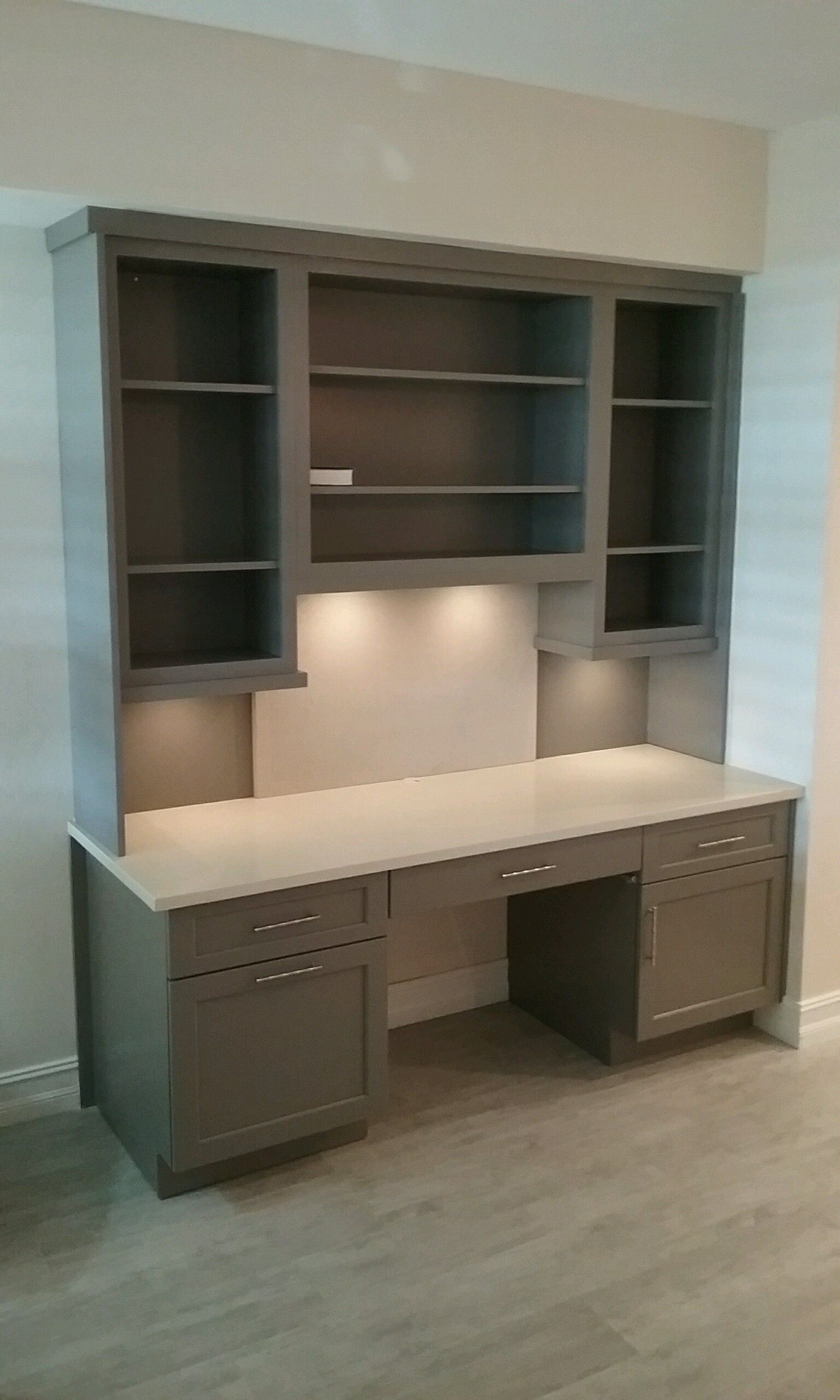 A large desk with shelves and drawers in a room.