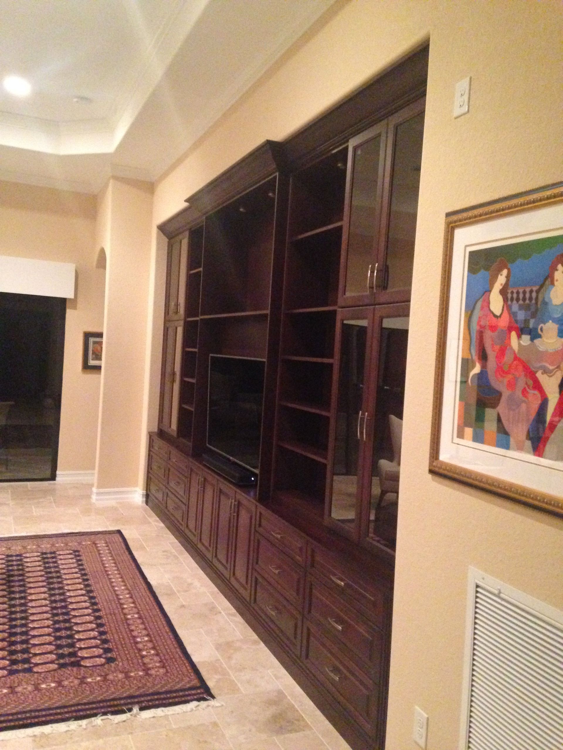 A living room with a rug and a picture on the wall