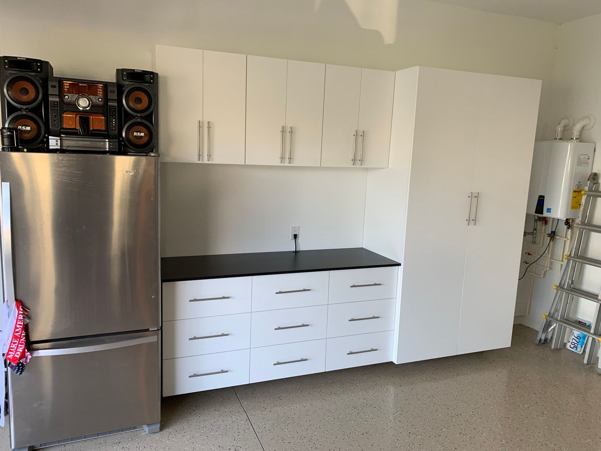 A kitchen with stainless steel appliances and white cabinets