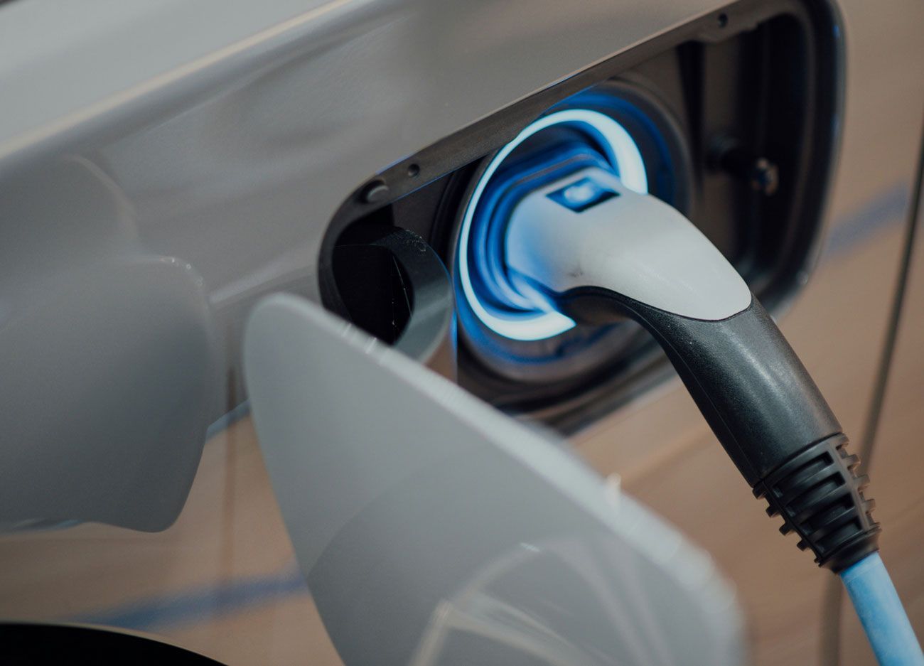 A close up of an electric car being charged.