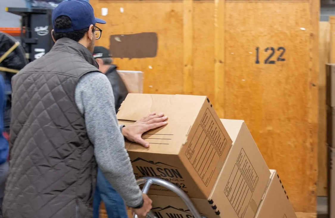 Pro movers with stack of boxes