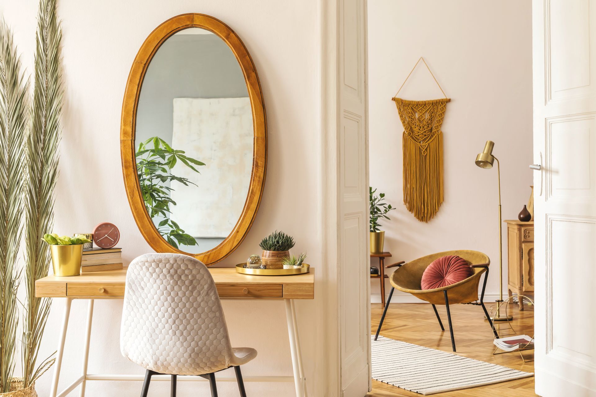 A room with a desk , chair , and mirror.