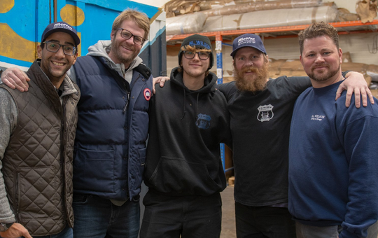 A group of men are posing for a picture together.