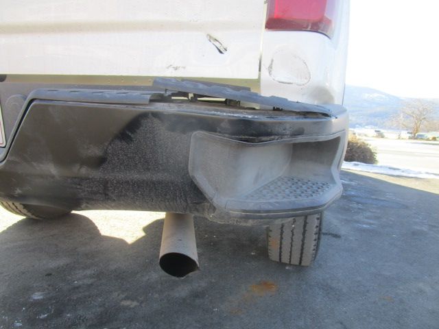 A car with a broken bumper is parked on the side of the road. Auto Body Repair in Colville, WA