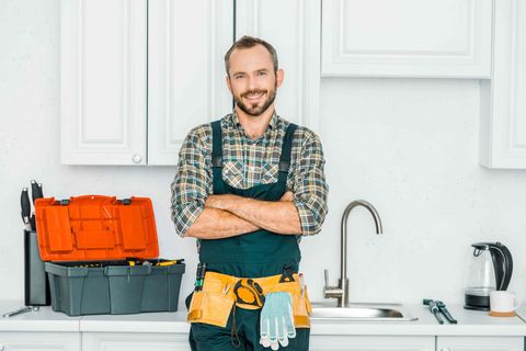 Plumber standing with crossed hands gesture
