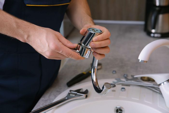 Plumber repairing the sink