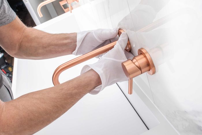 Man installing bathroom fixture