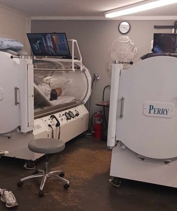 A futuristic white medical capsule with a glass window and interior bed sits in a bright, modern, sterile laboratory.