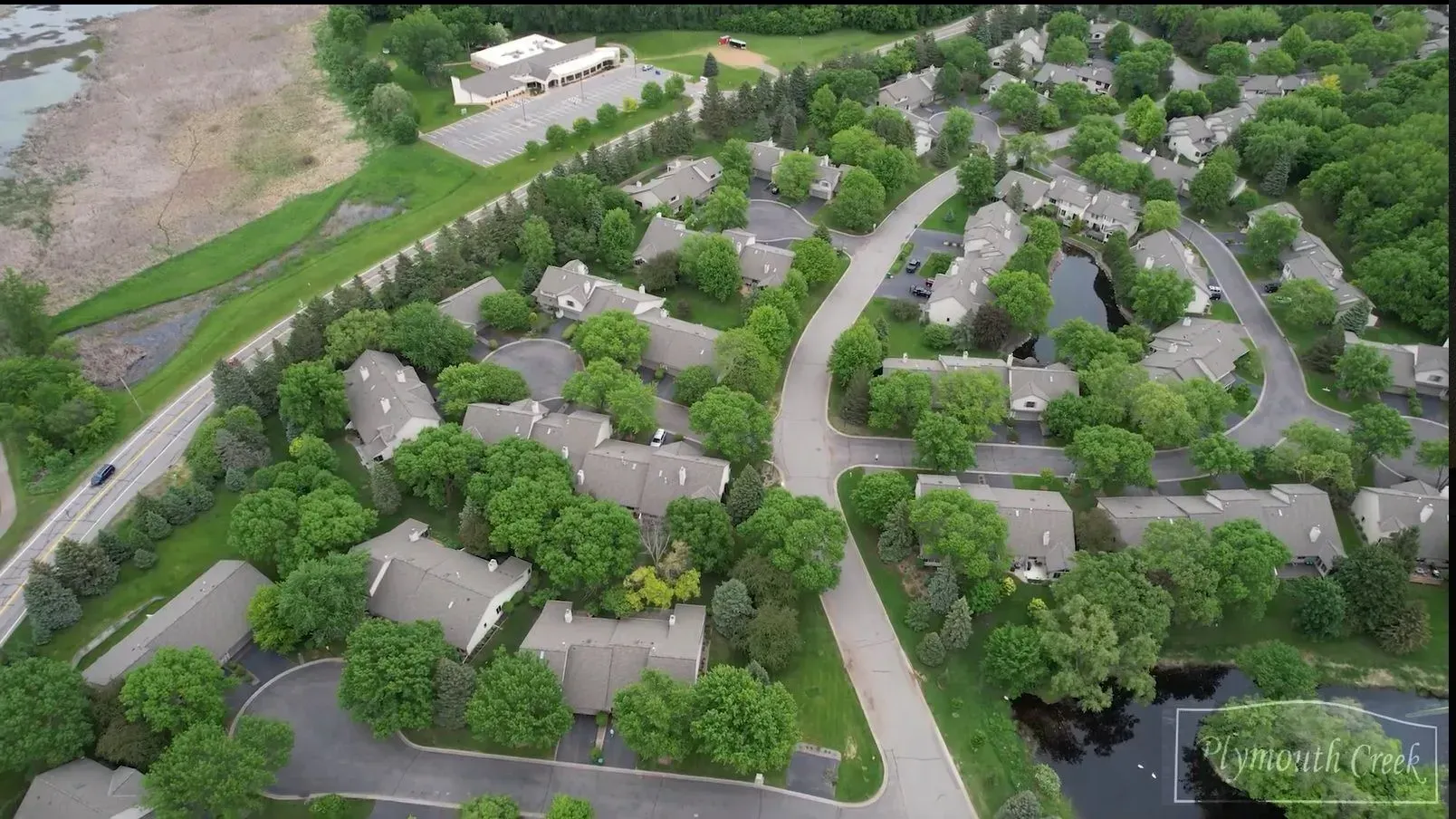 An aerial view of a residential area with houses and trees