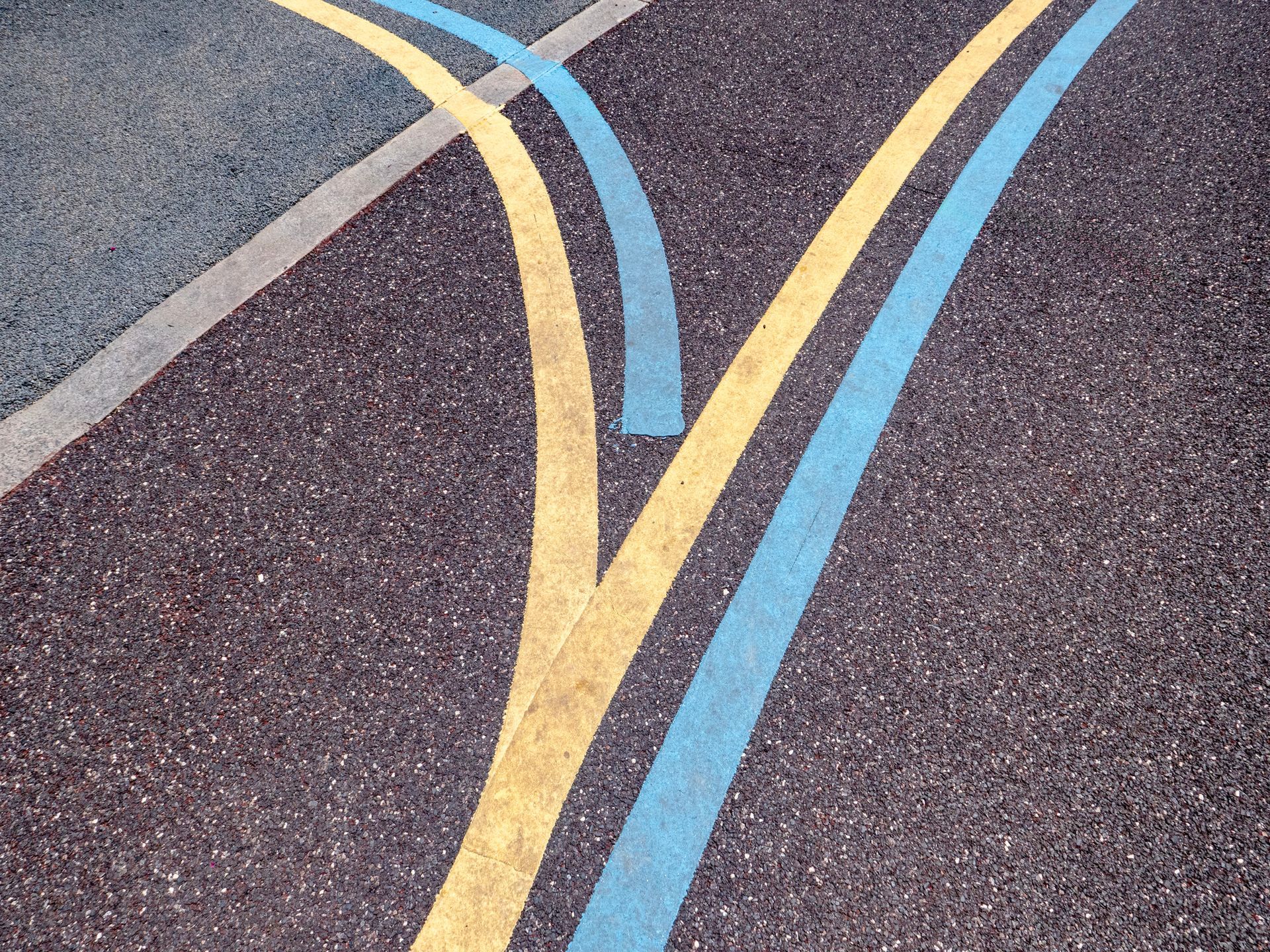 Yellow and blue lines diverging on asphalt road. Yellow and blue lines diverging on asphalt road.