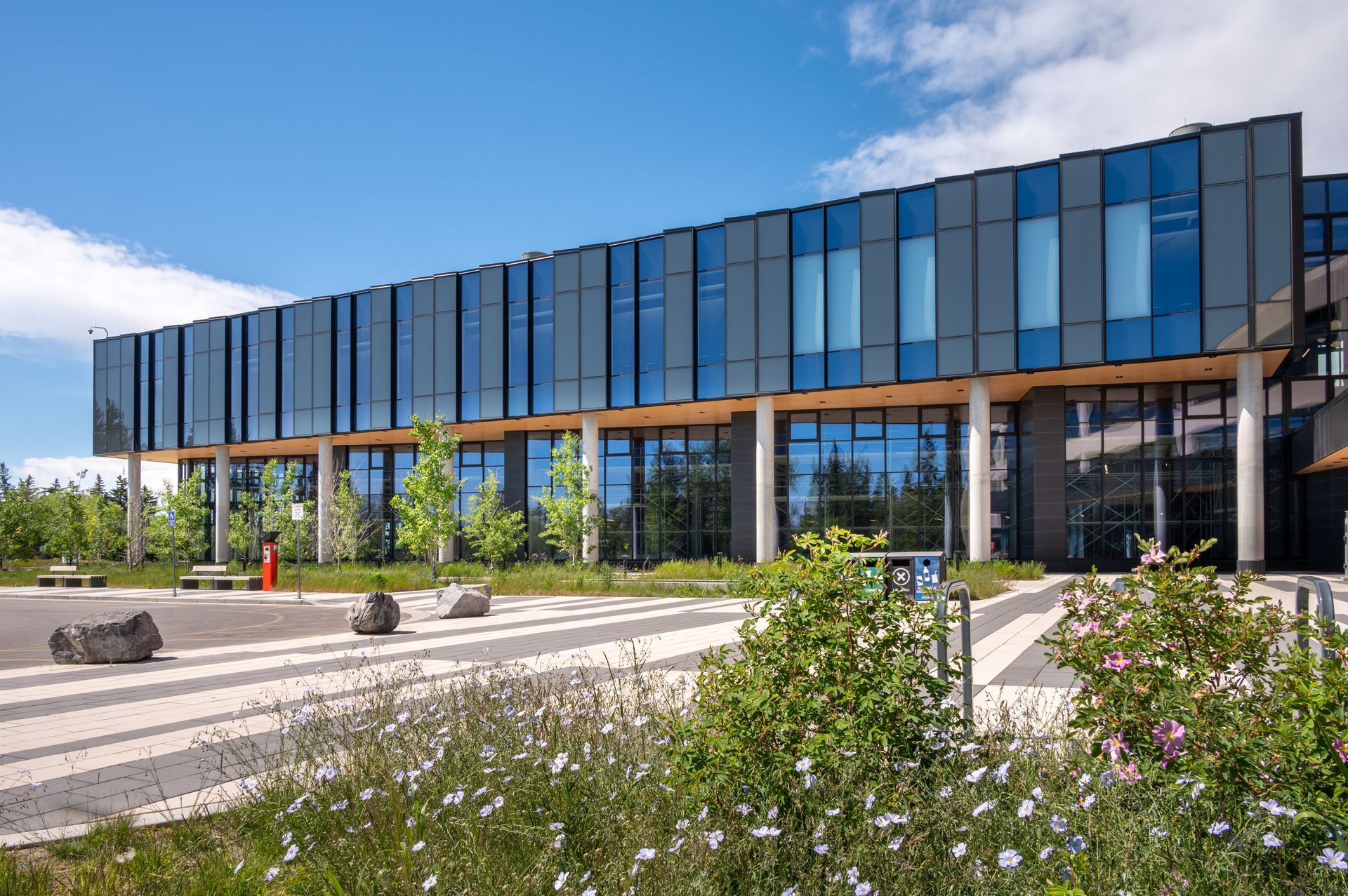 A large building with a lot of windows and flowers in front of it.